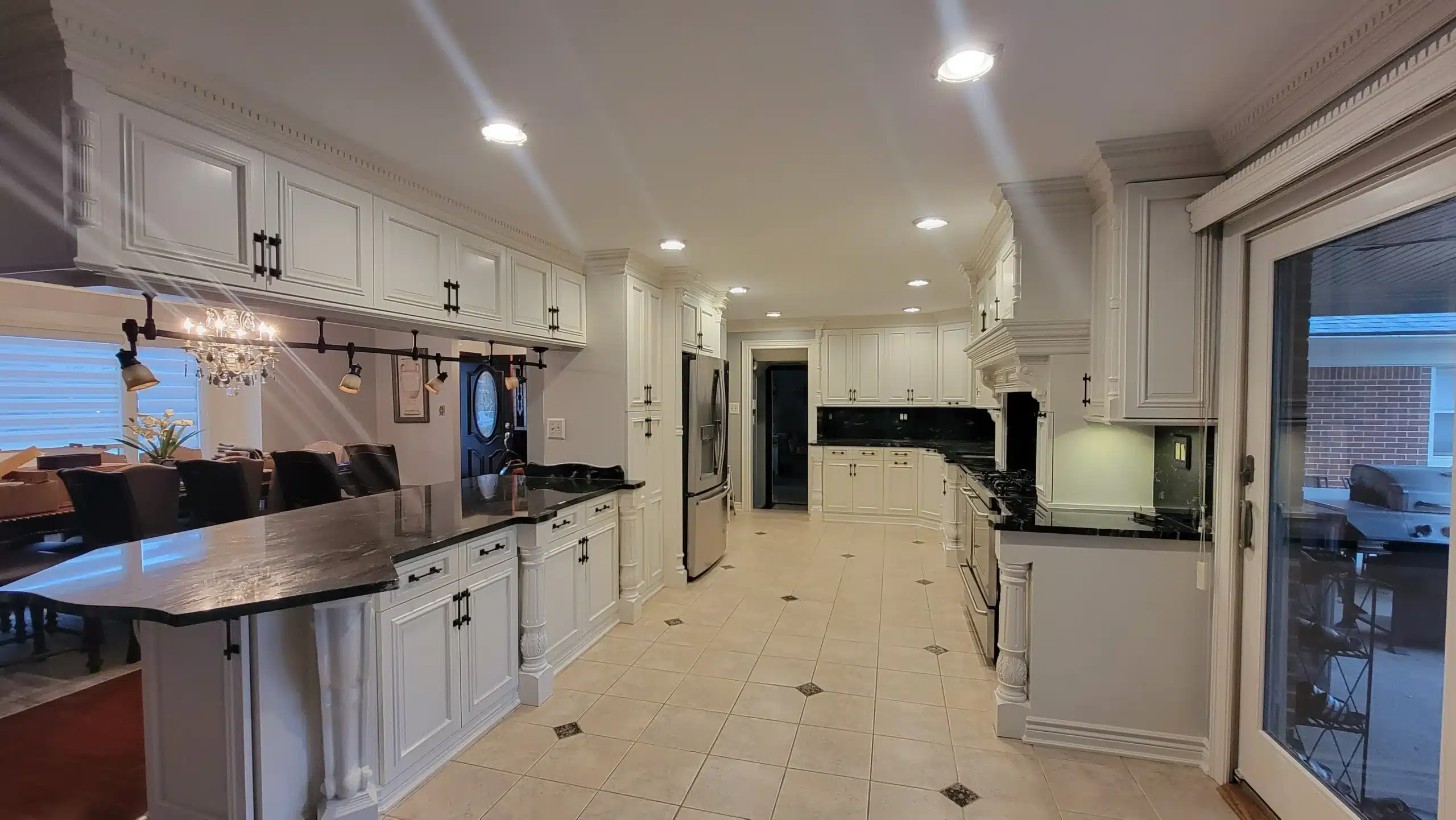 Expert Kitchen Cabinet Painting Services Beautifully updated kitchen featuring freshly painted white cabinets and dark countertops in Michigan.