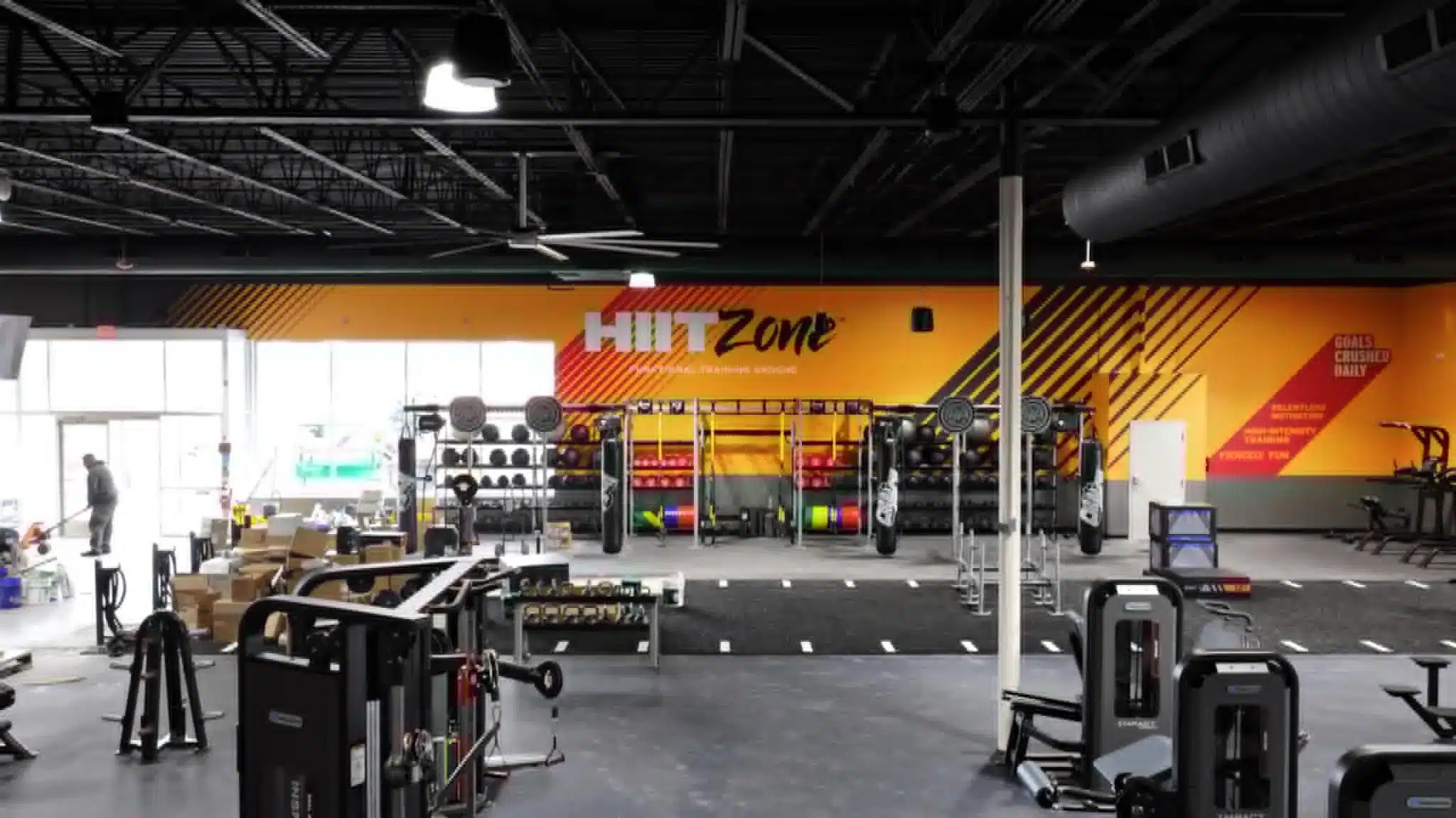 Commercial Gym Interior Painting Vibrant yellow and orange accent walls in a newly painted commercial gym interior in Michigan.